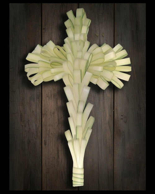 palm crucifix on wood surface